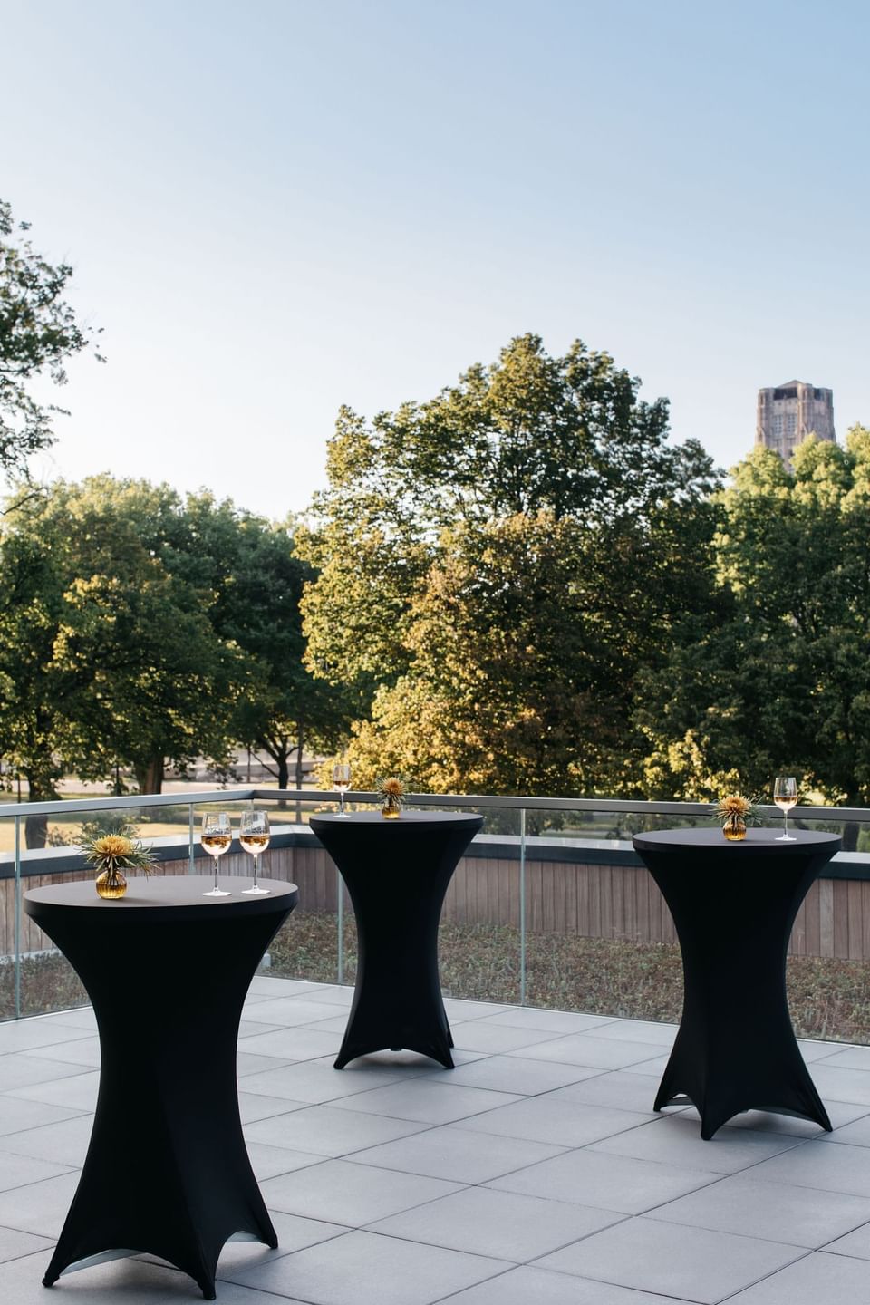 Rooftop Terrace with cocktail tables and glasses of wine in The Study at the University of Chicago