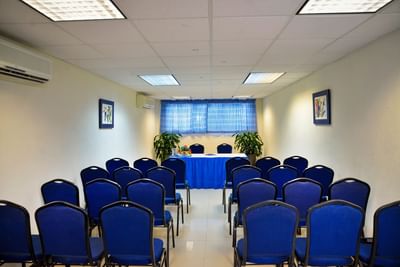 Meeting room with blue chairs and a table at Dover Beach Hotel