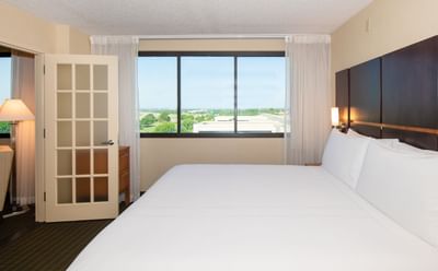 Bed in Premium King Suite at NCED Hotel and Conference Center