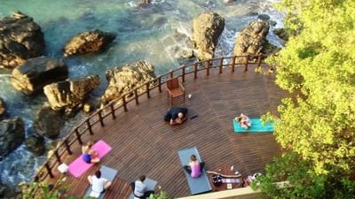 Aerial view of guests doing yoga on deck at Cala de Mar