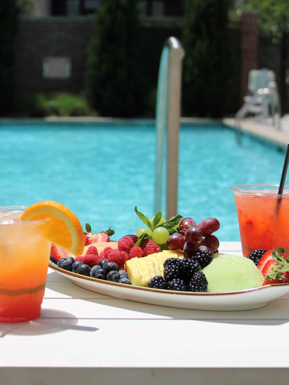 Summer Splash Staycation showing pool, drinks and fruit platter