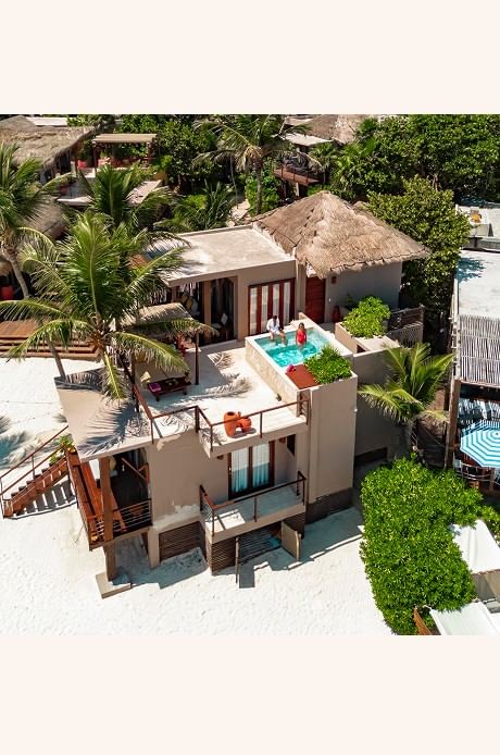 Aerial view of a luxurious beachfront suite at La Zebra Hotel featuring a private rooftop terrace and plunge pool