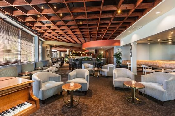 Interior of a lounge with a piano at Handlery Hotel