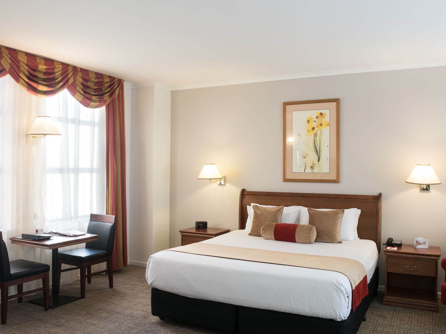 Work desk by the king bed in Executive Room at Hotel Grand Chancellor