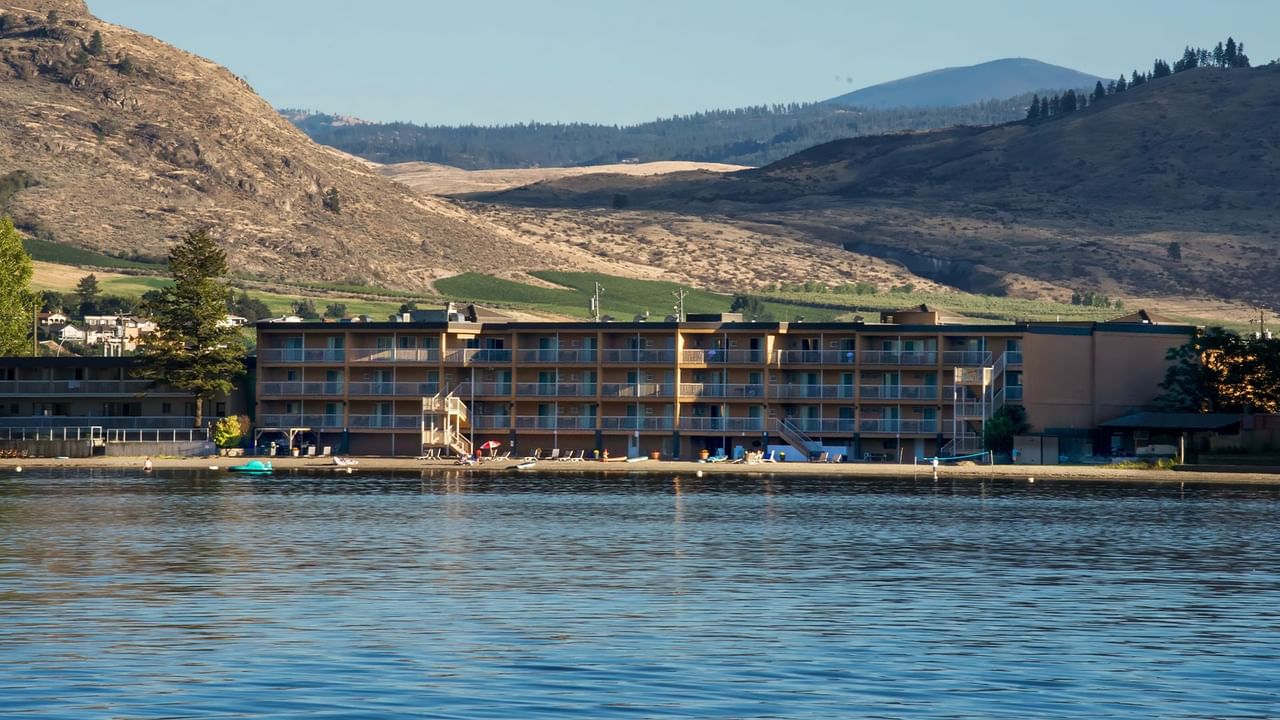 Osoyoos beach hotel exterior with water and mountains