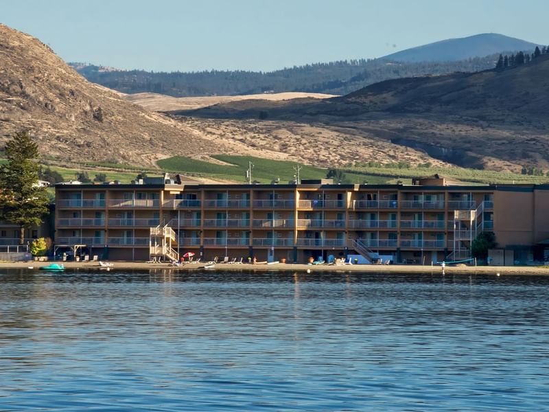 Osoyoos beach hotel exterior with water and mountains