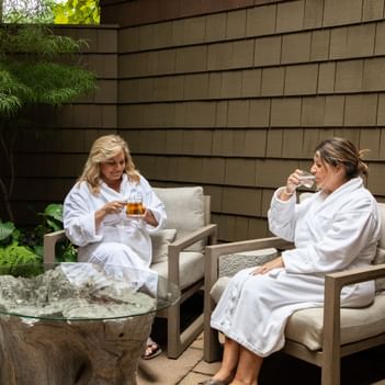Two ladies having tea in the Spa outdoors at Alderbrook Resort & Spa