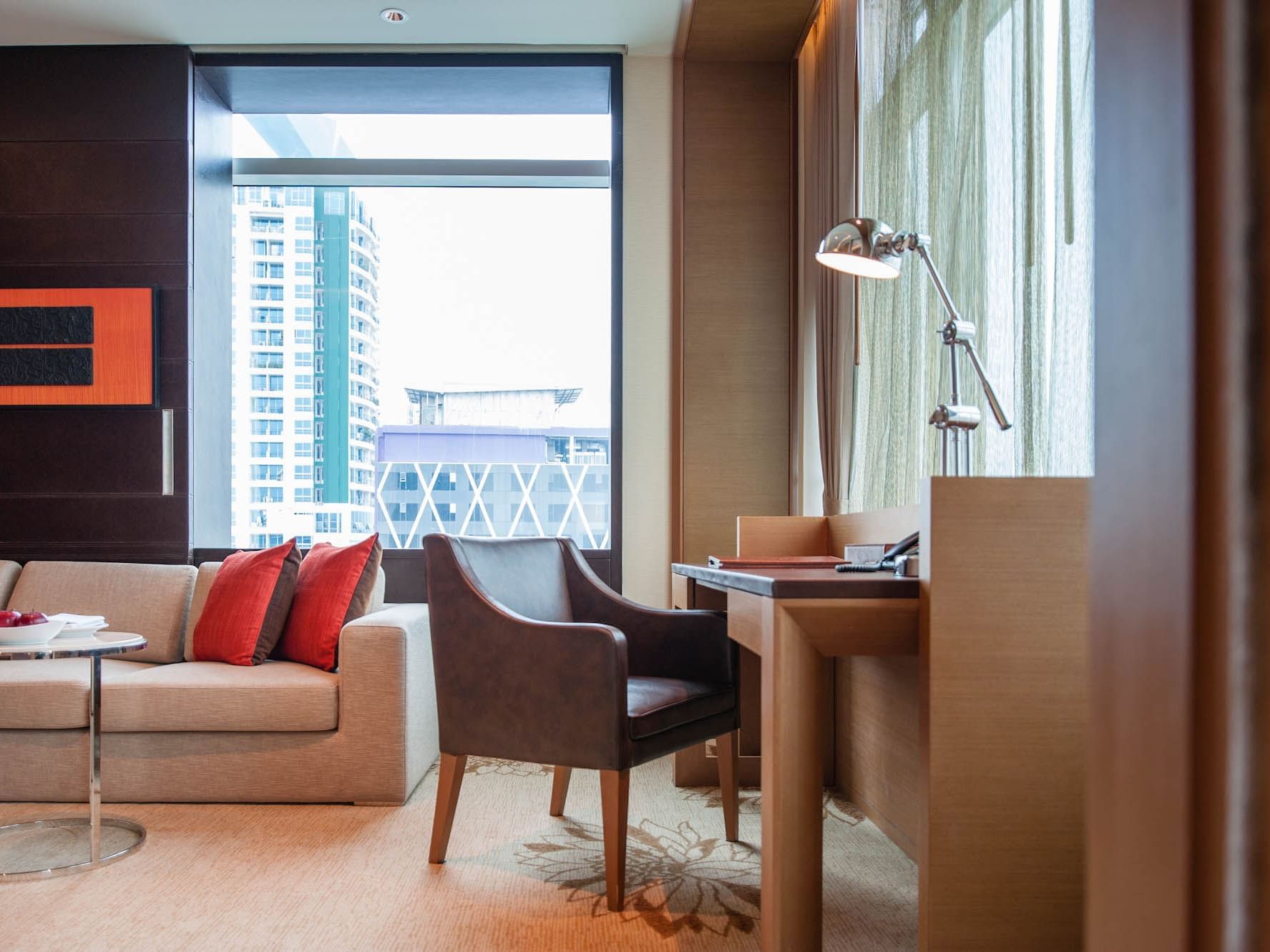 Living area with working desk at Eastin Hotels