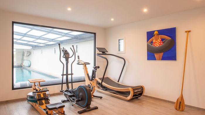 The fitness center with exercise machines at Originals Hotels