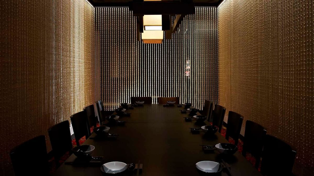 Dining room with a long table and chairs in Spice Temple Restaurant at Crown Hotel Melbourne