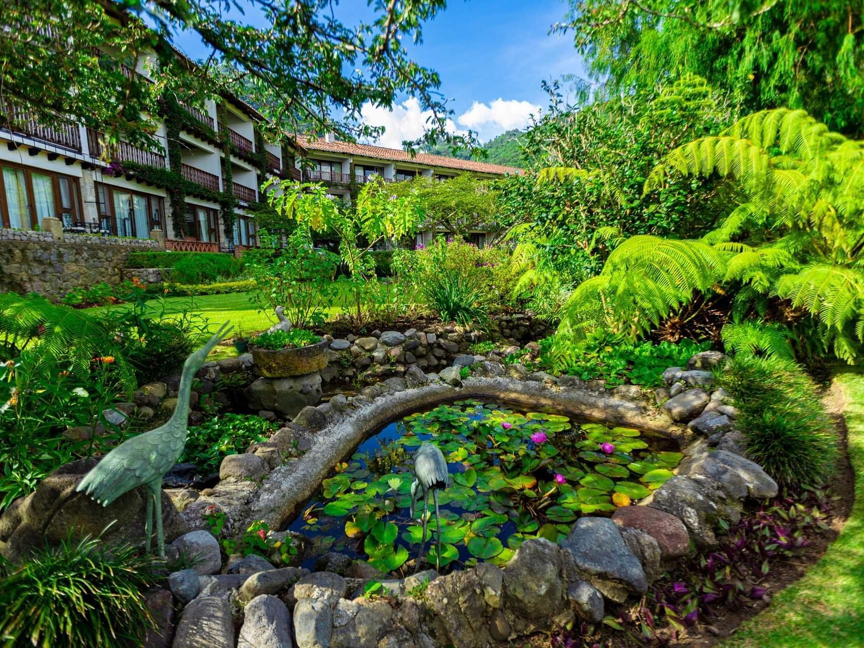 Bird statues & flowers by the pond at Hotel Atitlan