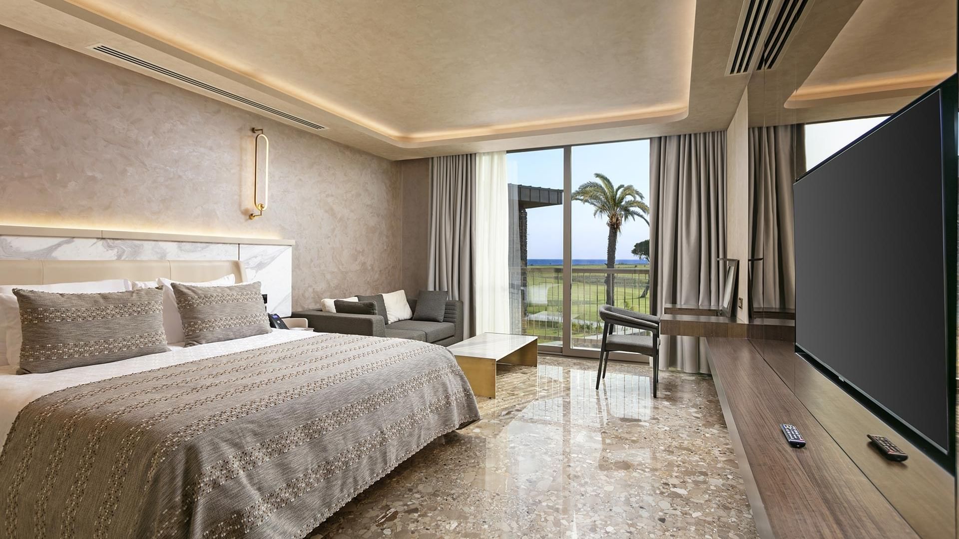 TV facing the bed in Cullinan Villa's Bedroom with marble-tilled floor at Cullinan Belek