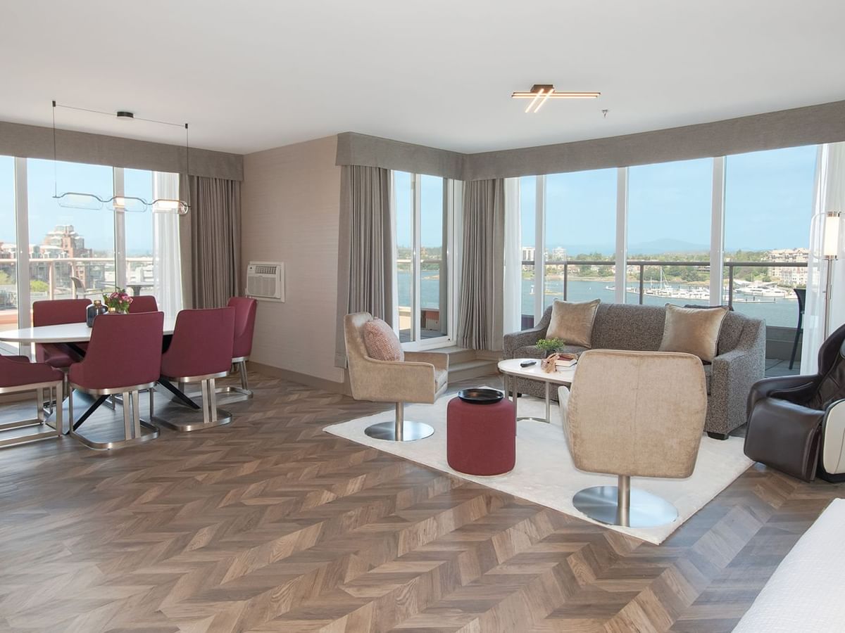 Hotel guestroom with wrap-around balcony, massage chair, and living area