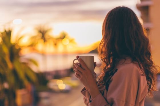 A woman having a coffee at Sunseeker Resort