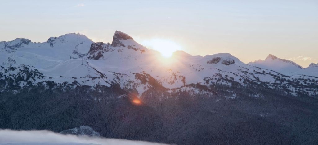 January in Whistler sunrise over snow covered mountain peaks.