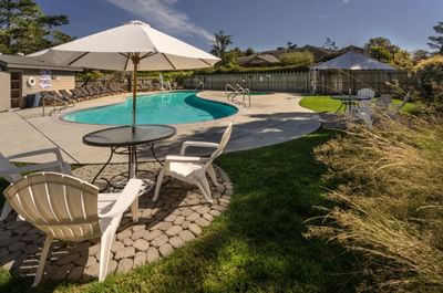 Swimming pool and tables with umbrellas