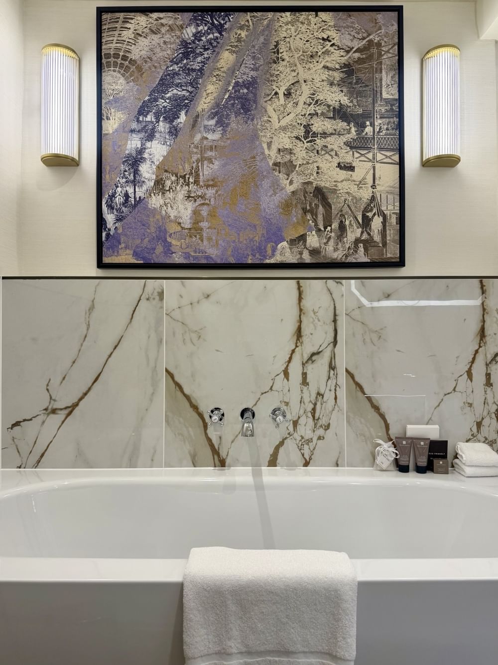 Suite bathroom with marble vanity, modern fixtures, and abstract artwork at The Capital Hotel, Apartments & Townhouse - London