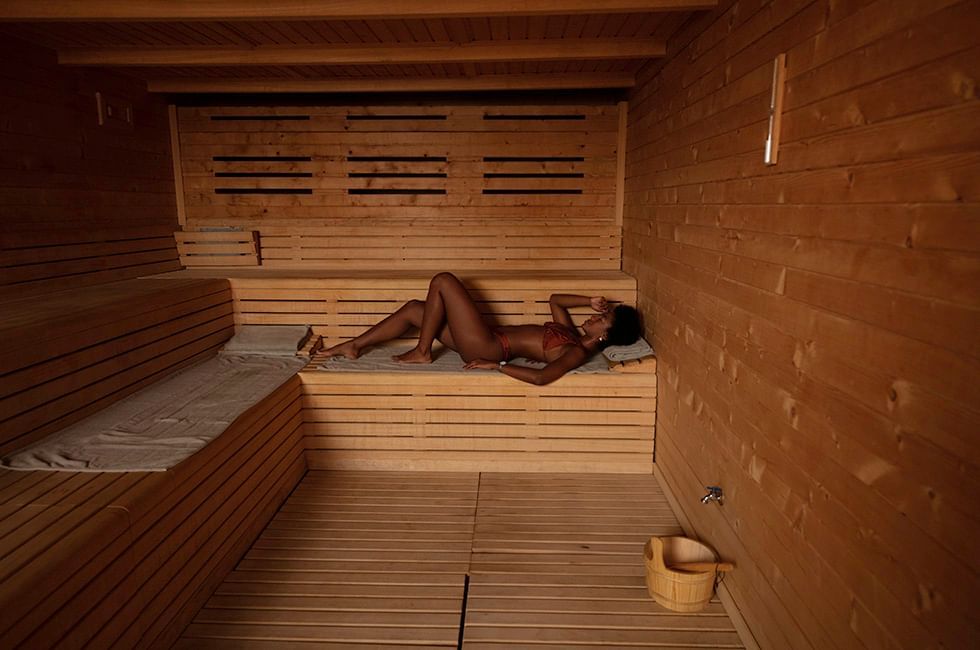 Woman relaxing in a sauna at Live Aqua Resorts and Residence Club