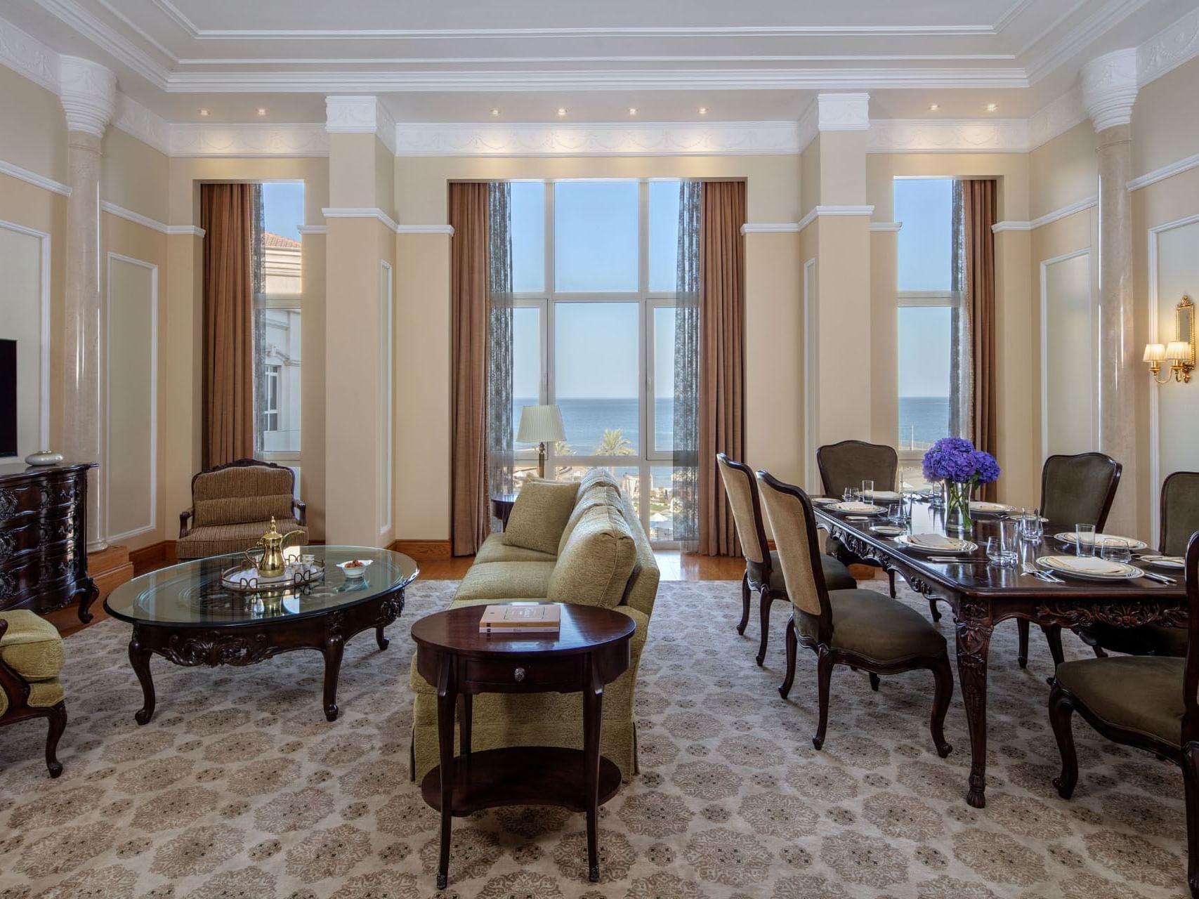 Dining table & a couch in Regency  Suite at The Regency Hotel