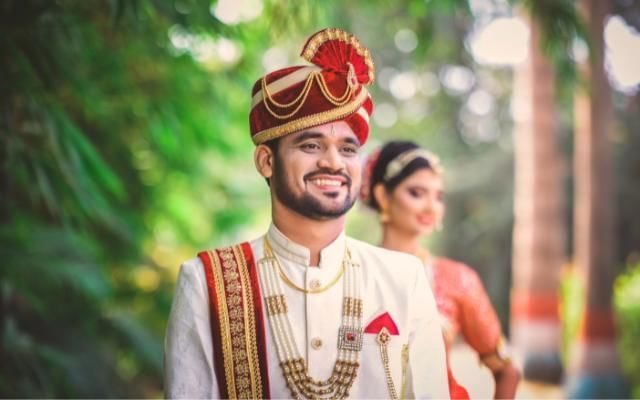 Hindu weddings featuring grrom and bride in the gardens at Easthampstead Park in Wokingham