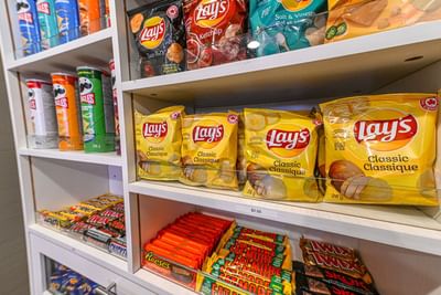 Shelf displaying a variety of chips and snacks at Encore Suites Grande Prairie