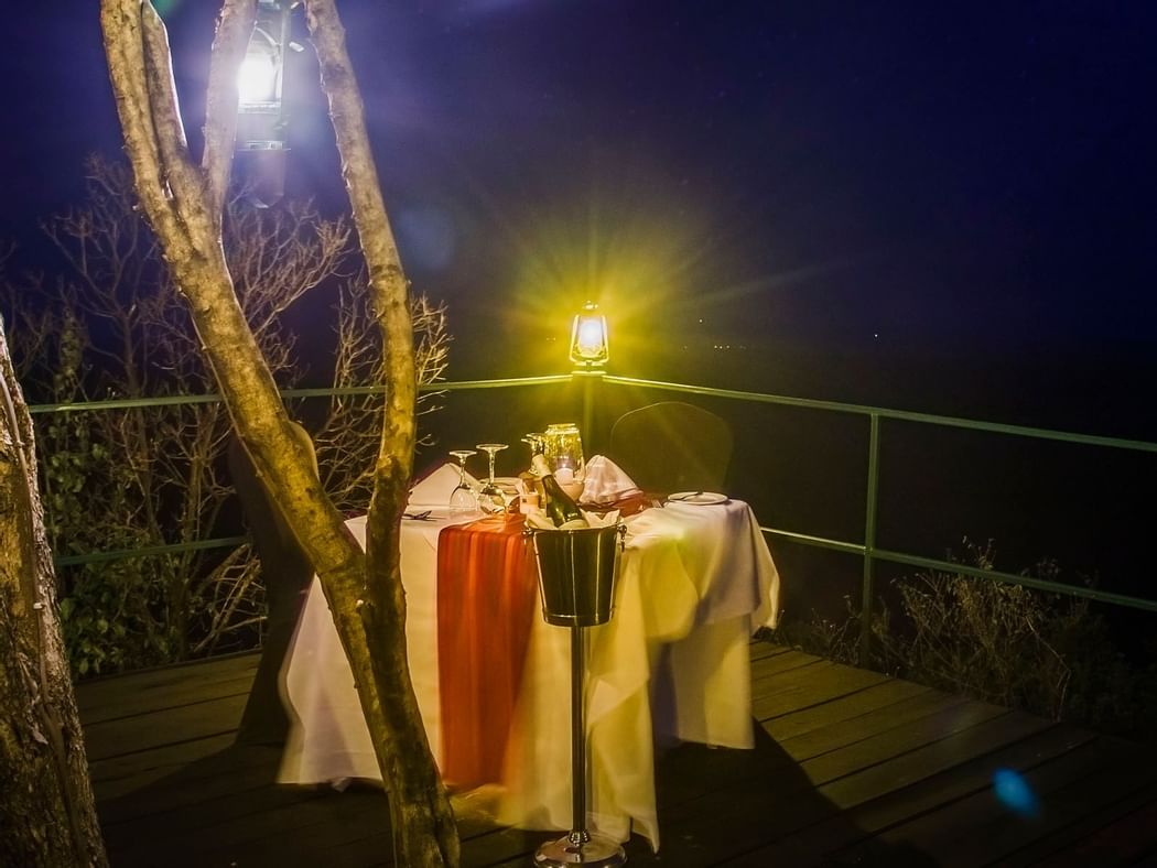 A dining table at night in Mara Serena Safari Lodge