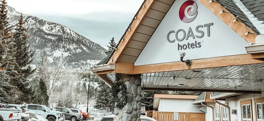 Coast Hotels entrance with a snowy mountain backdrop.