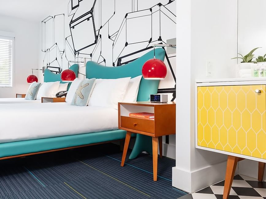 Skylark double room at Vagabond Hotel Miami, ft. 2 double beds , geometric wall art and vibrant midcentury modern design.