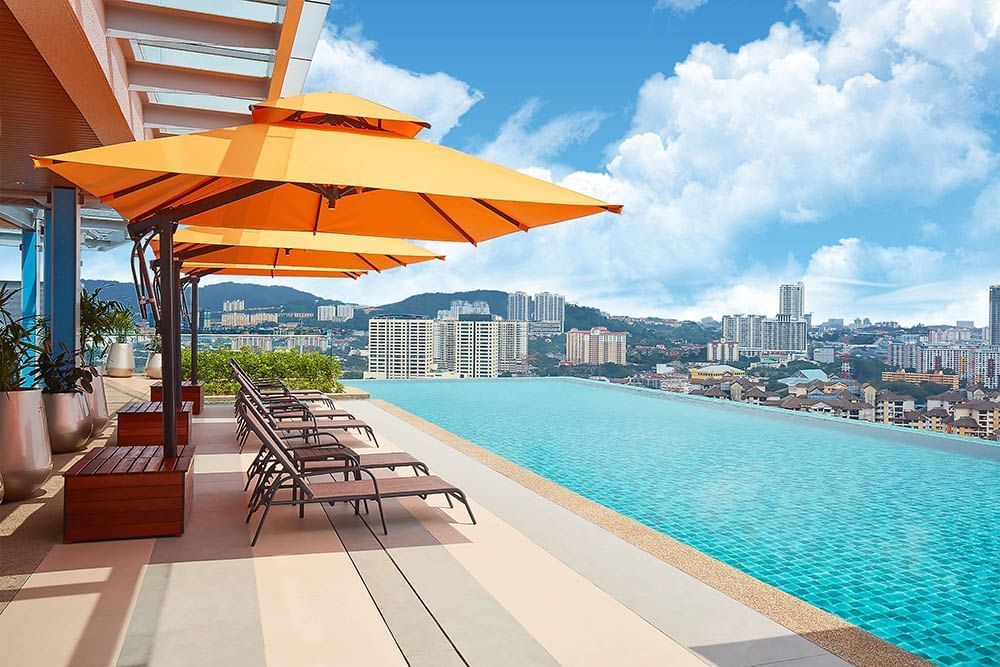 Infinity swimming pool at Sunway Velocity Hotel with deck chairs