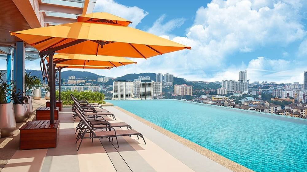 Infinity swimming pool at Sunway Velocity Hotel with deck chairs