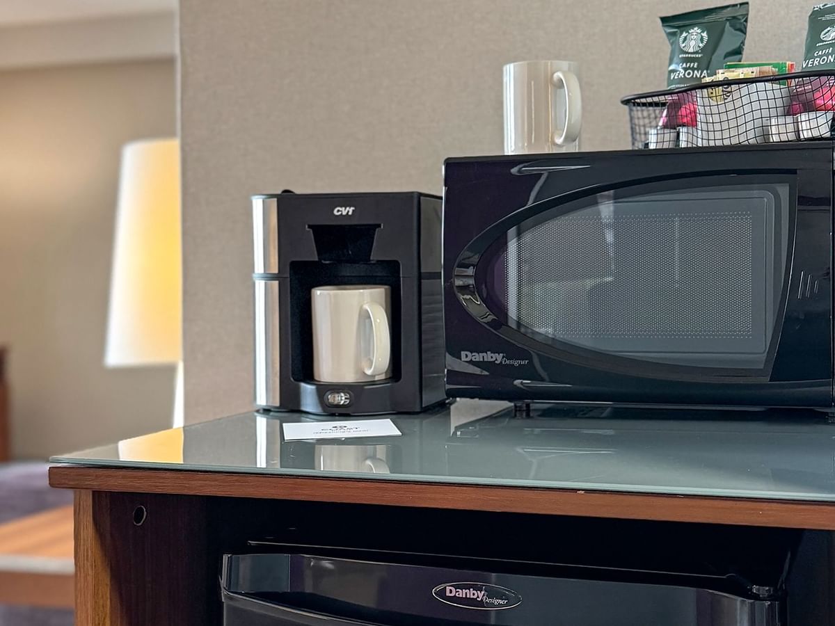 A coffee maker, microwave and minifridge