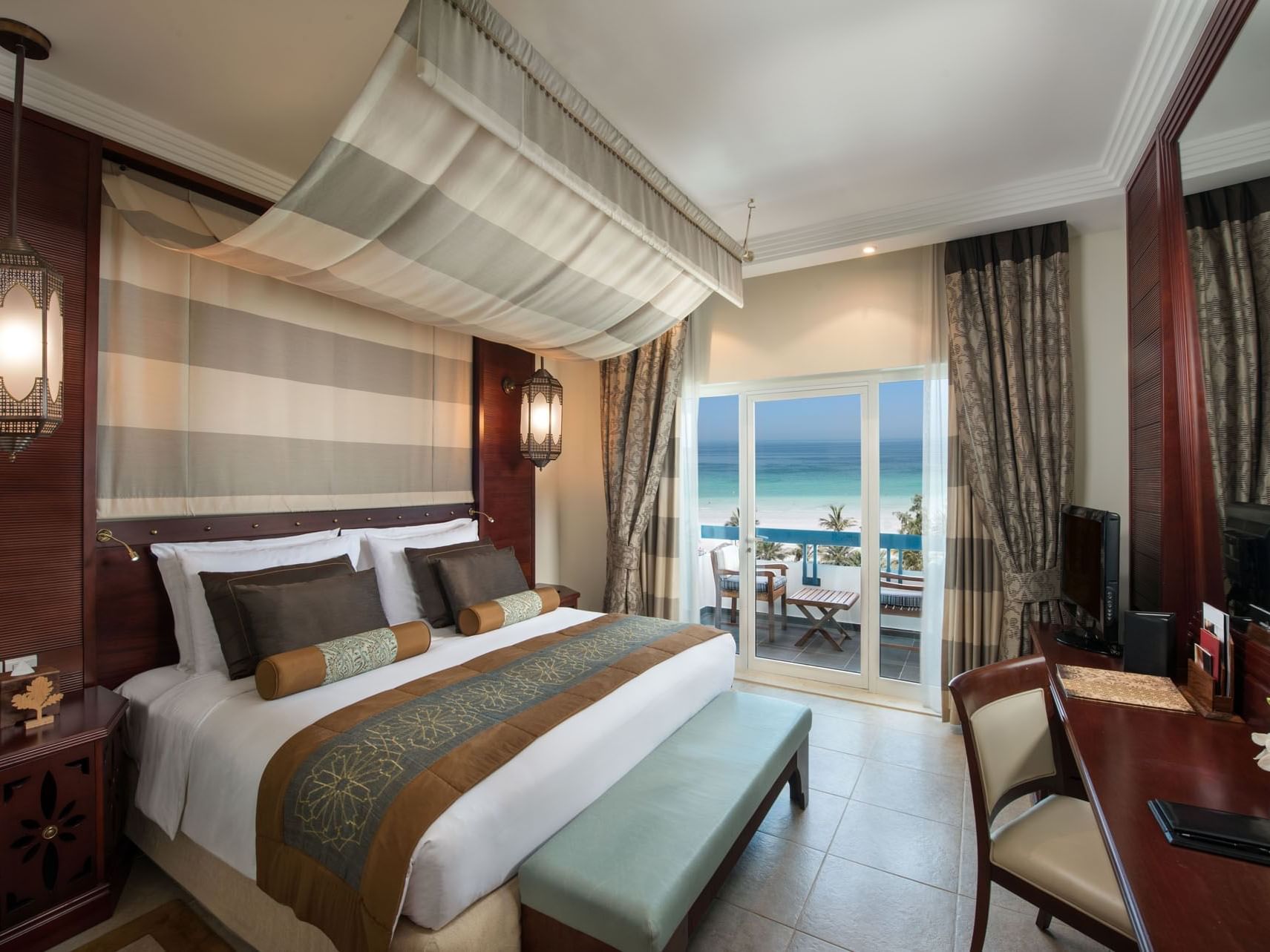 King bed in Sea View Deluxe Suites at Ajman Hotel