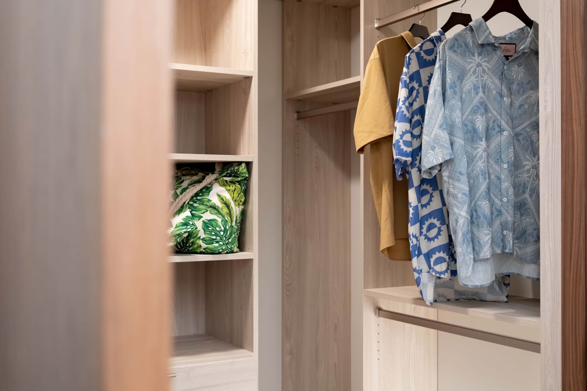 A closet with wooden shelves and hanging clothes