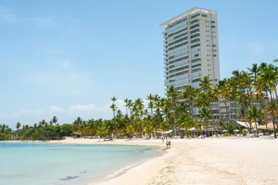 Beach area with the hotel exterior at Club Hemingway