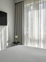 TV facing bed near window in Penthouse René-Lévesque at Warwick Le Crystal Montreal
