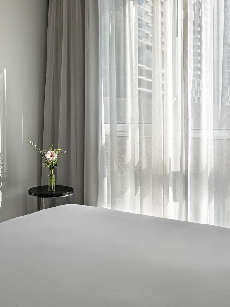 White bed with window view in Penthouse René-Lévesque at Warwick Le Crystal Montreal.