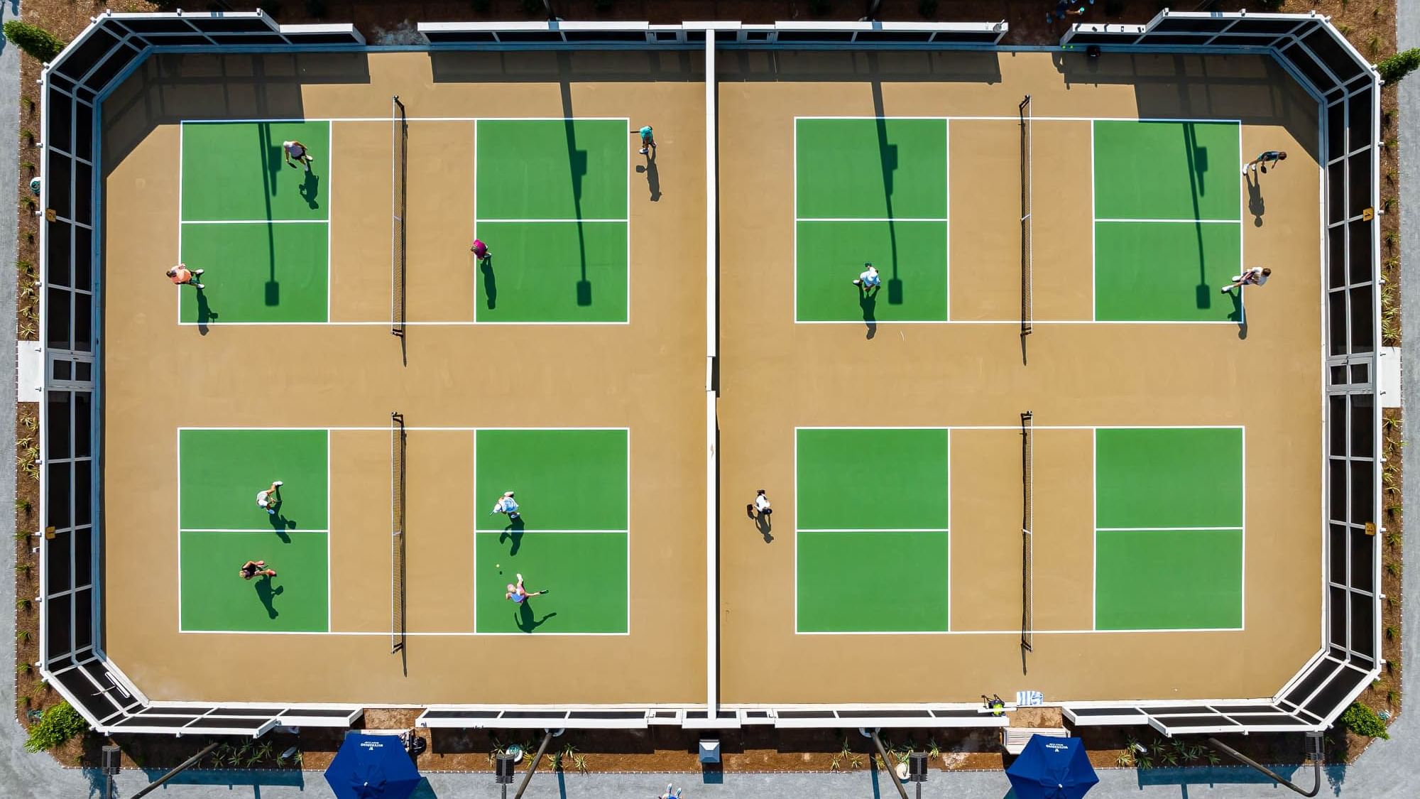 Aerial view of players playing in a Pickleball court at Camp Creek Inn