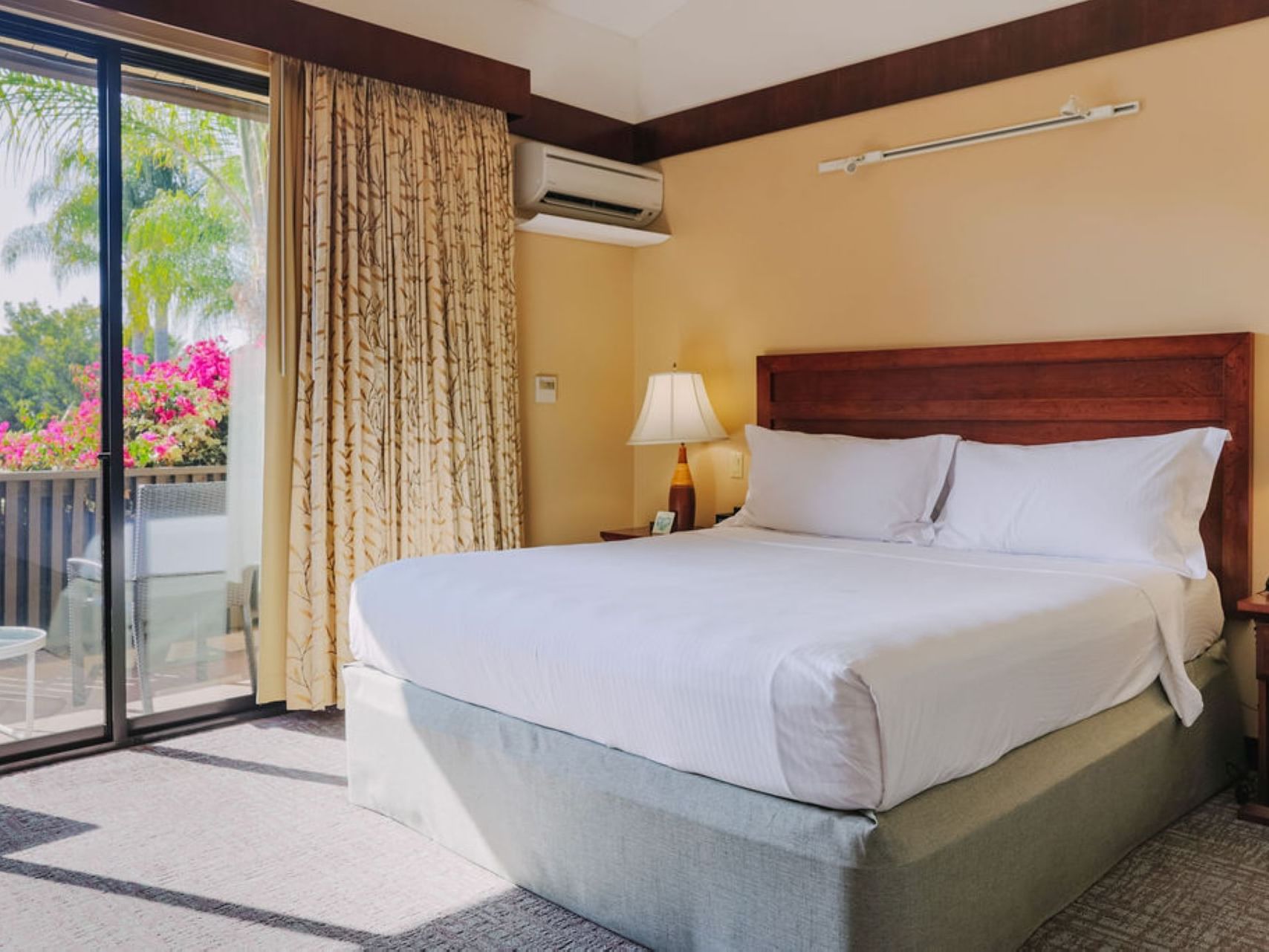 Large bed & balcony in Garden Deluxe at Dinah's Garden Hotel