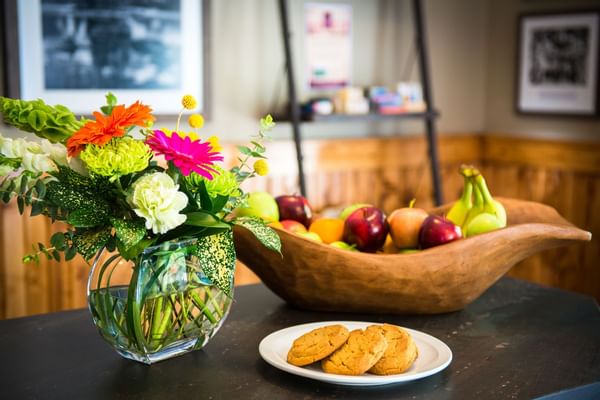 Flowers, fruit and cookies on table