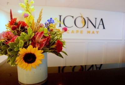 A vase of flowers rests on the check-in counter at our hotel near Cape May