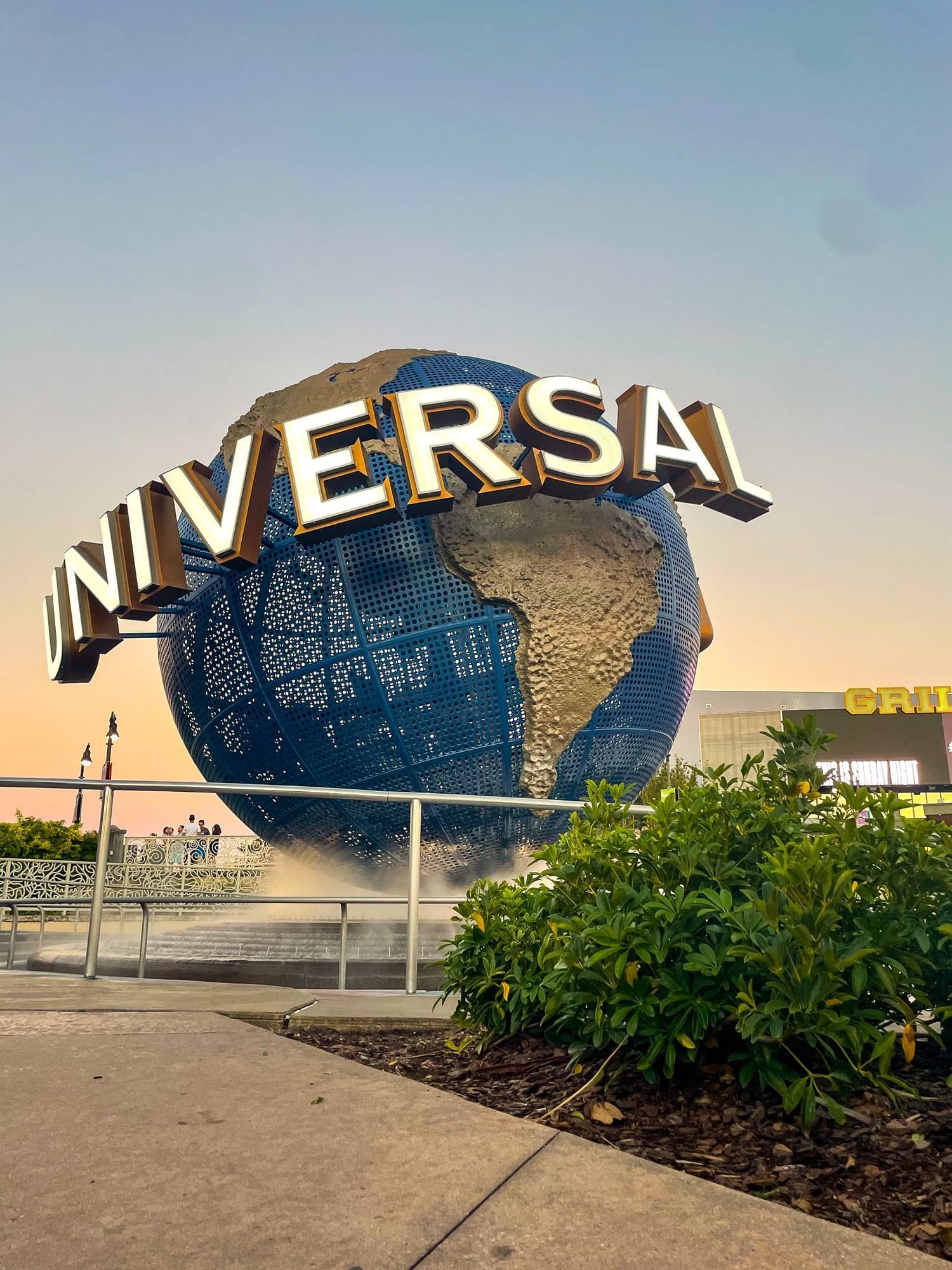 The iconic Universal globe in front of Universal Studios Florida at sunset.