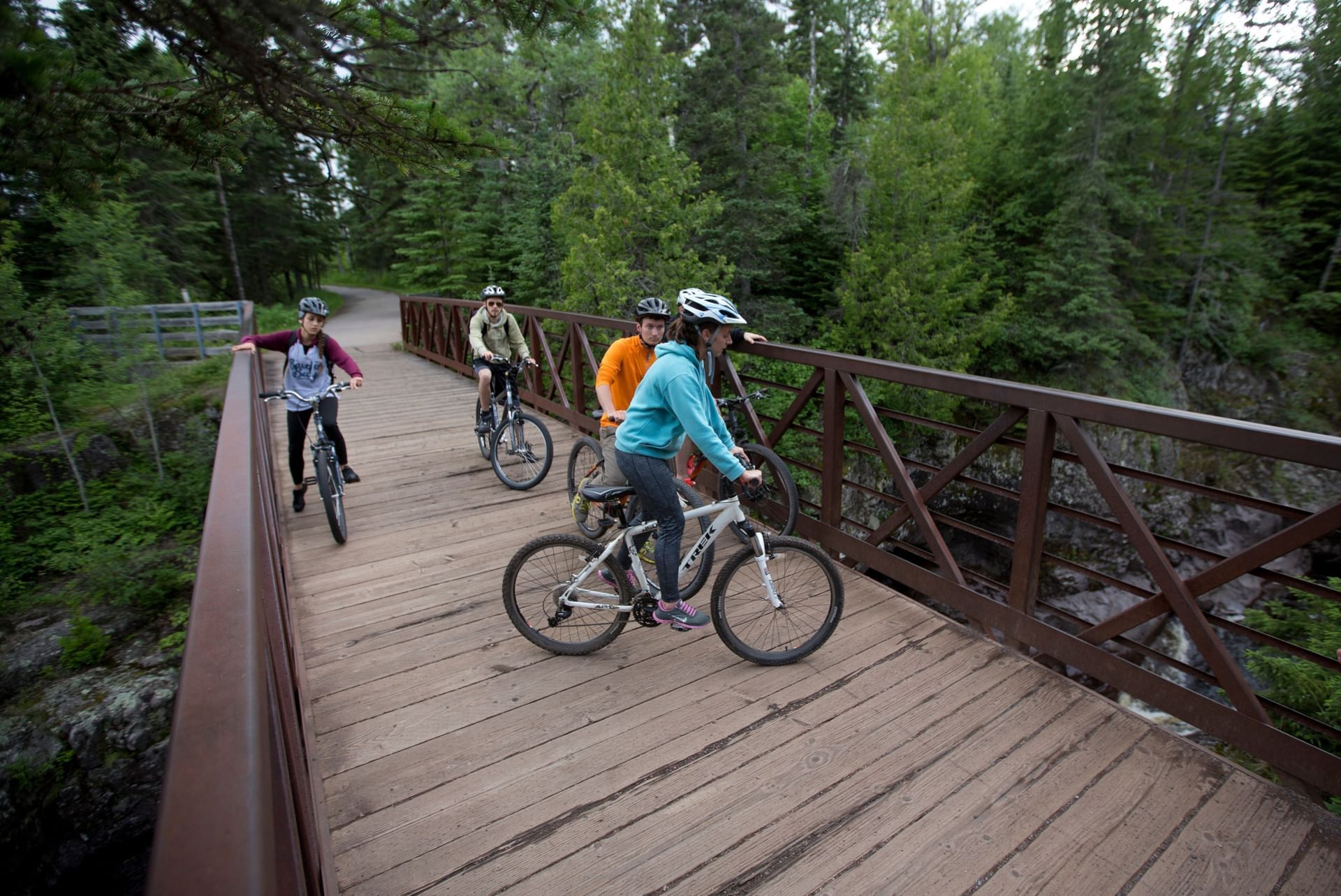 Kids on bikes on a bridge near Bluefin Bay Family of Resorts