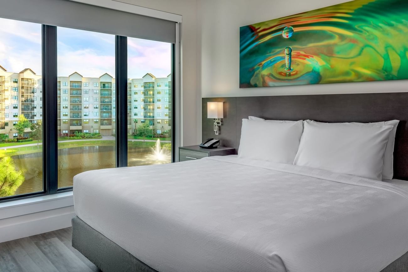 Terraces Two Bedroom ADA Shower Suite with large windows overlooking buildings at The Grove Resort & Water Park