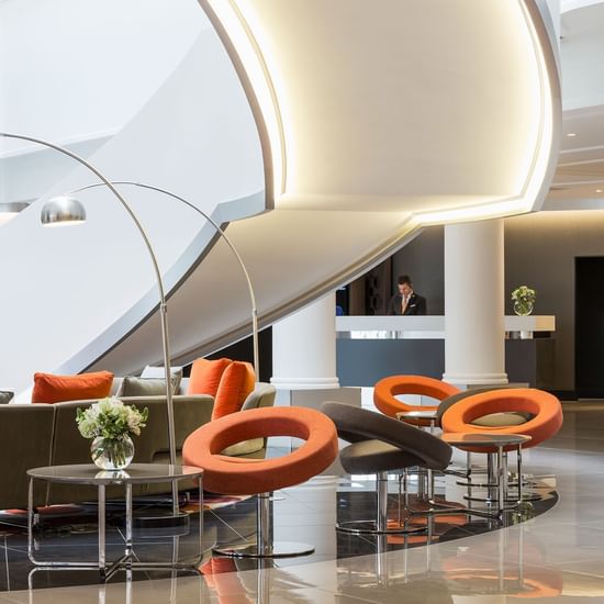 Illuminated lobby lounge area by the staircase at Pullman Albert Park