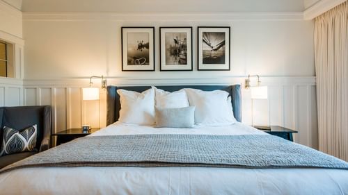 Comfy king bed with hanging wall paintings in Premium Resort suite at Watersound Inn