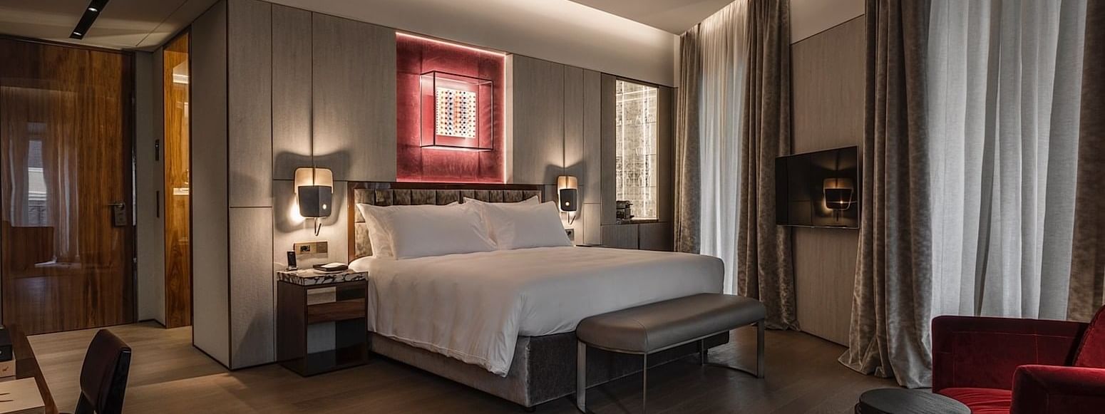 Comfortable bed in Deluxe Suite 3 at Fendi Private Suites