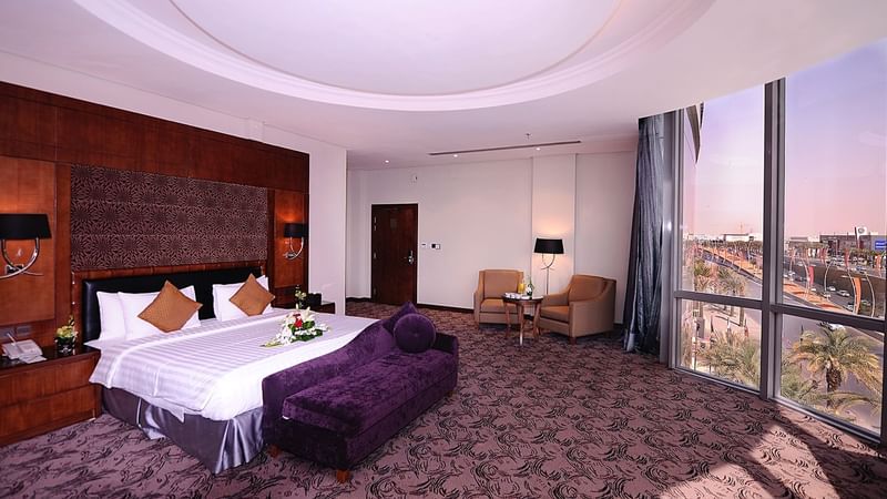 Bed with couch & nightstand in Panoramic Suite at Al Hamra Palace by Warwick Riyadhd