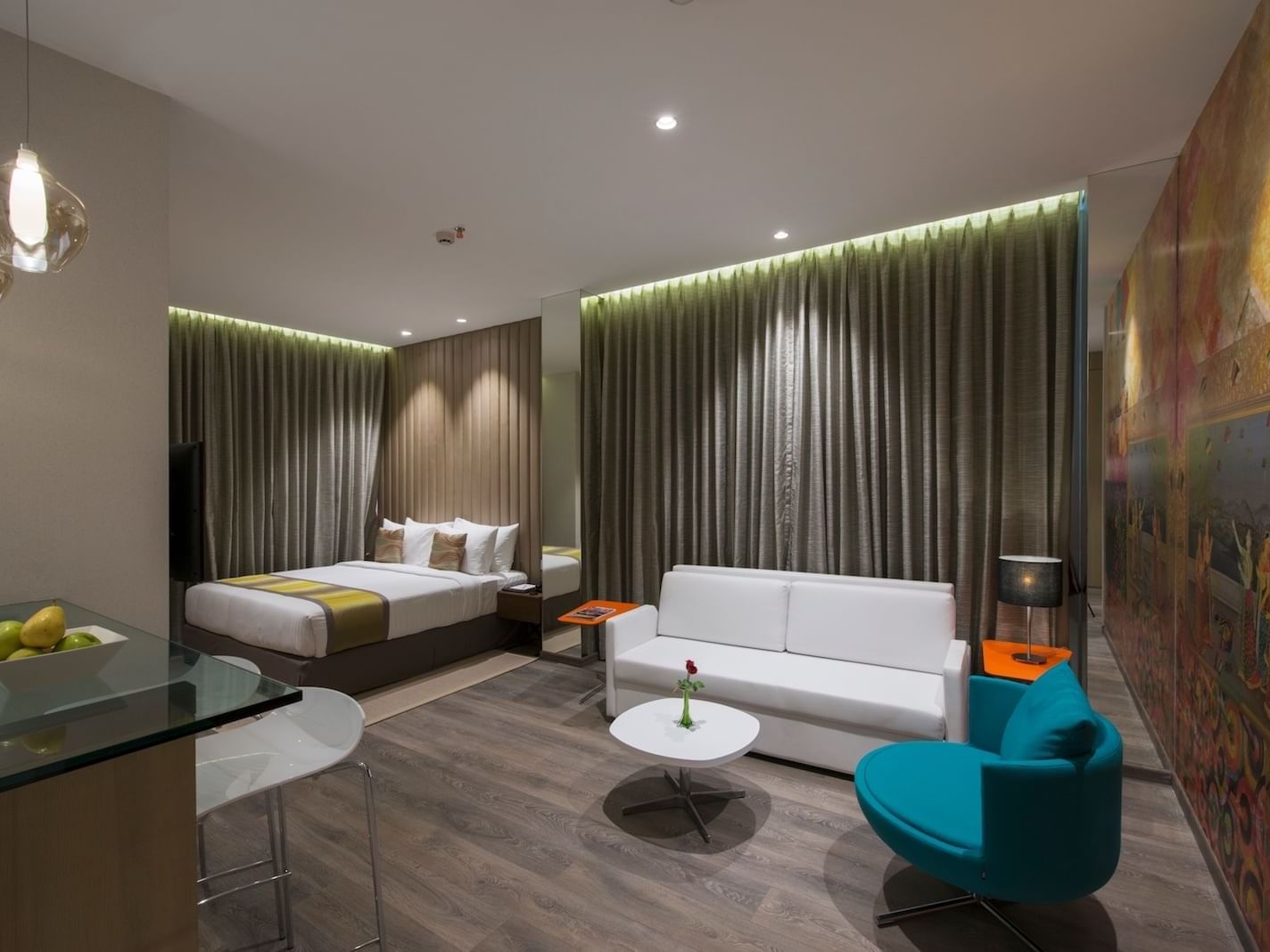Deluxe Studio bed and sitting area at Eastin Hotels