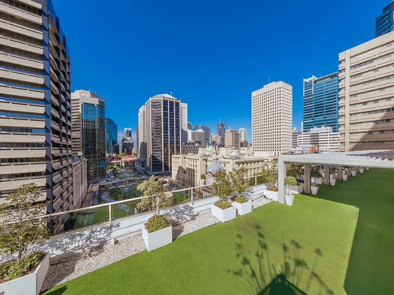Rooftop garden with artificial grass and skyline view in Soiree Deck at Sofitel Brisbane Central