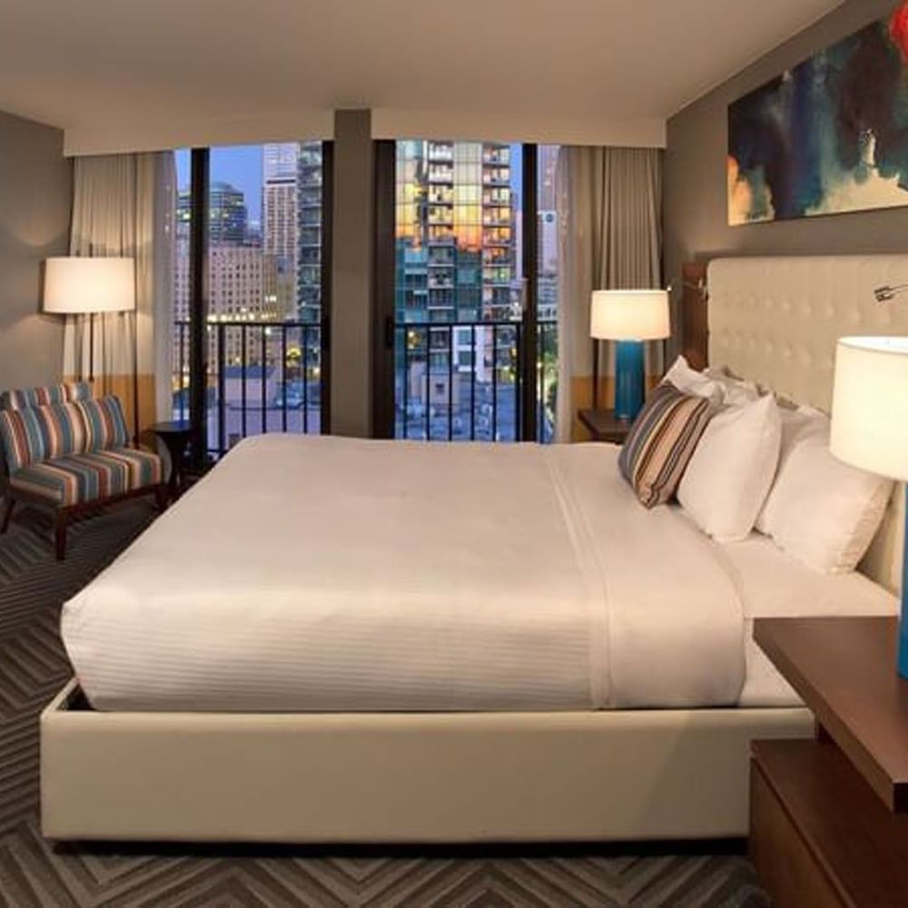 Stylish Evergreen Suite with a king bed, balcony, and city view at Warwick Seattle in Seattle.
